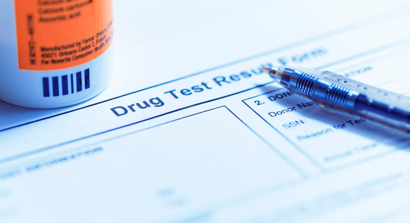 Drug test result form on a clipboard